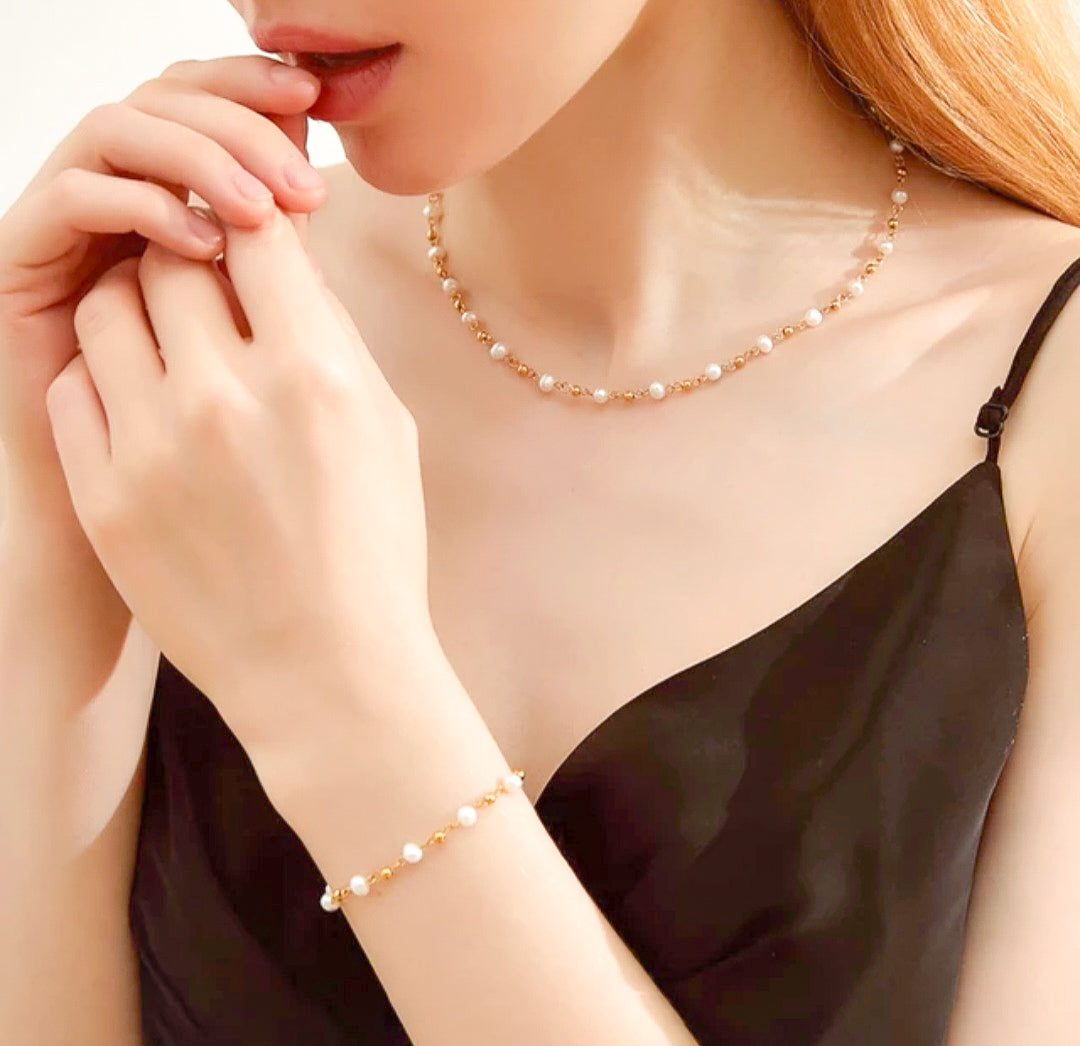 Pearl bracelet and pearl necklace on a girl