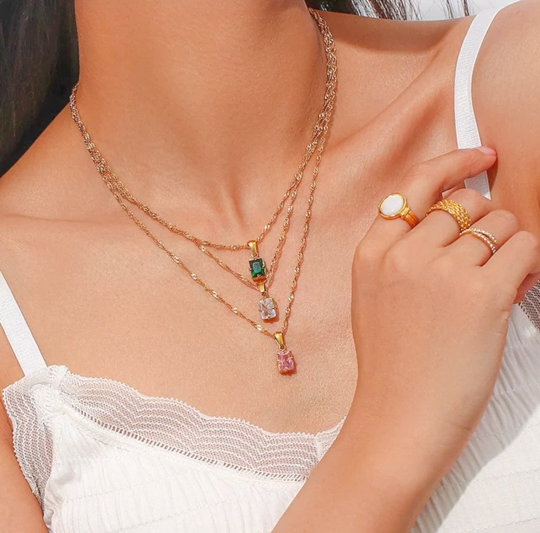 Gold plated zircon pendants in color green, pink and white on a model