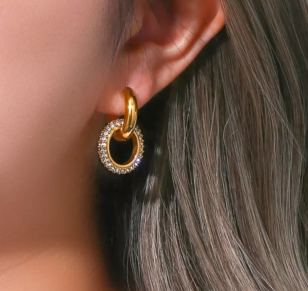 Gold plated hoop in hoop earrings with zircons on model